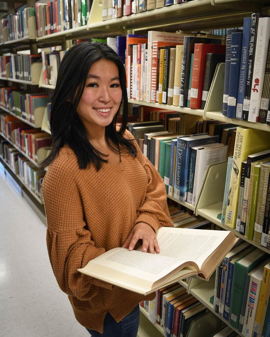 A student in the library on the Wallace Drive Campus